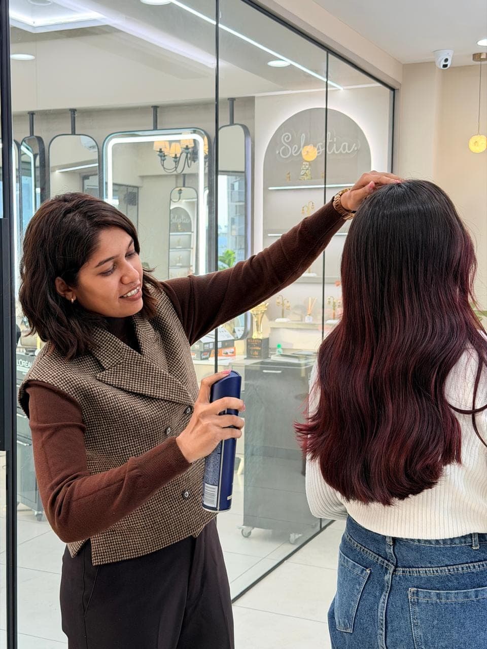 Vidhi setting a wine-red hair colour at Selestia, the best ladies salon in Rajkot