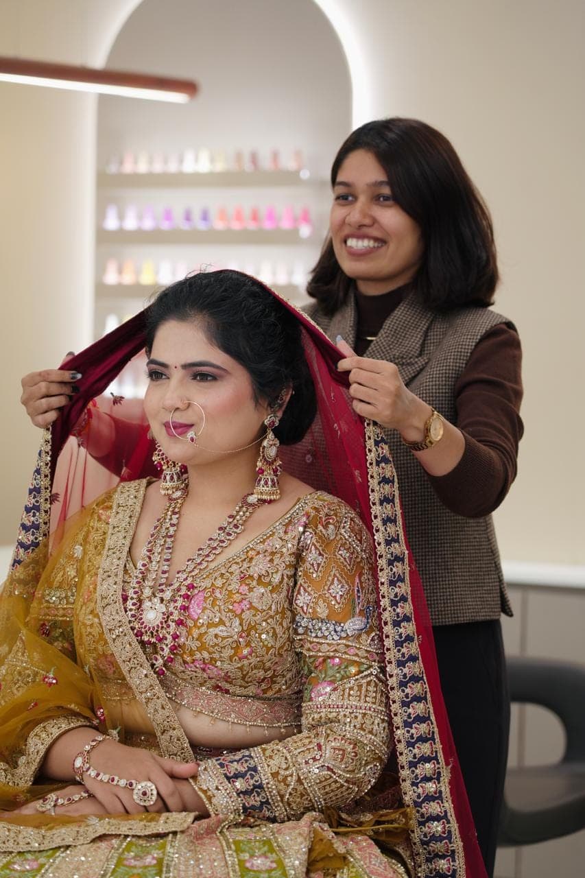 Bride in a gold lehenga after her bridal make-up at Selestia salon, Rajkot