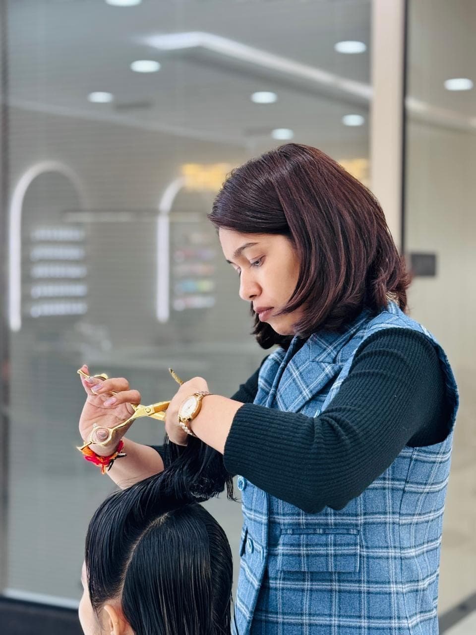 Vidhi shaping a layered haircut at Selestia salon, Rajkot